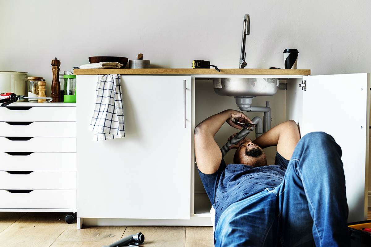 Plumber man fixing kitchen sink